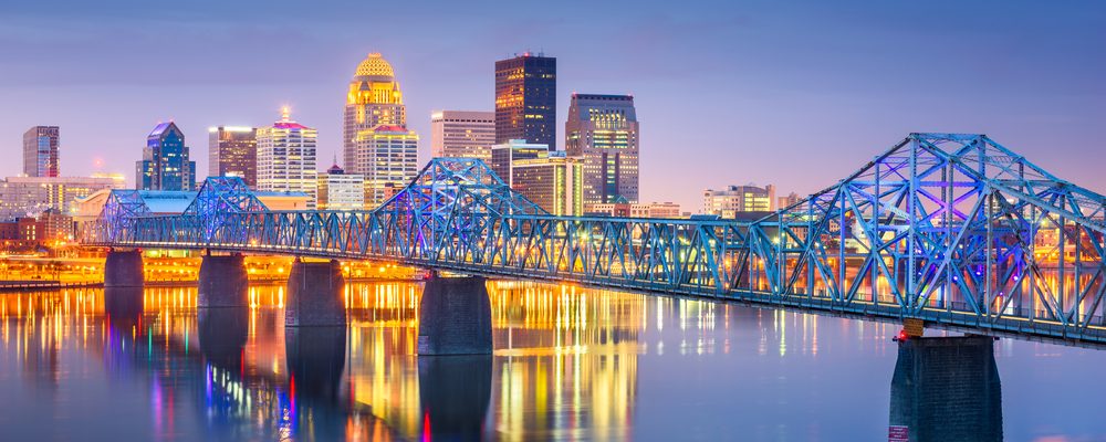 The Louisville skyline at dusk, behind the Ohio River bridges